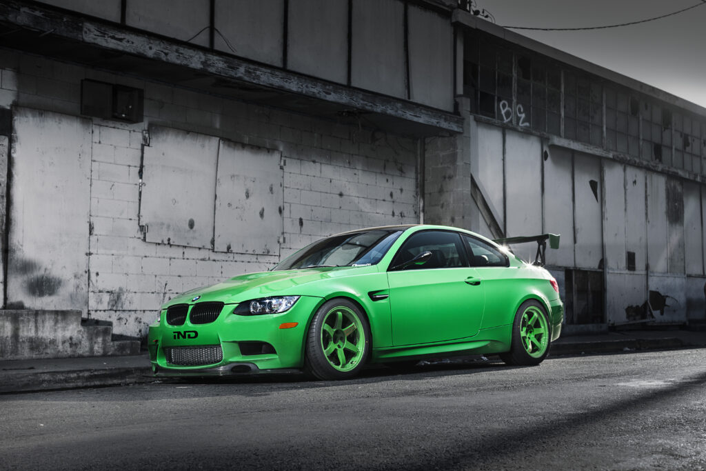 Vibrant Green BMW M3 E92: Striking Side View in Urban Setting Wallpaper