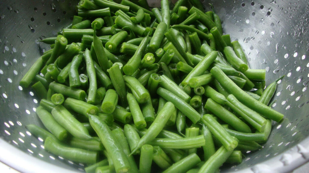 Vibrant Green Beans Sliced in Stainless Steel Colander Wallpaper