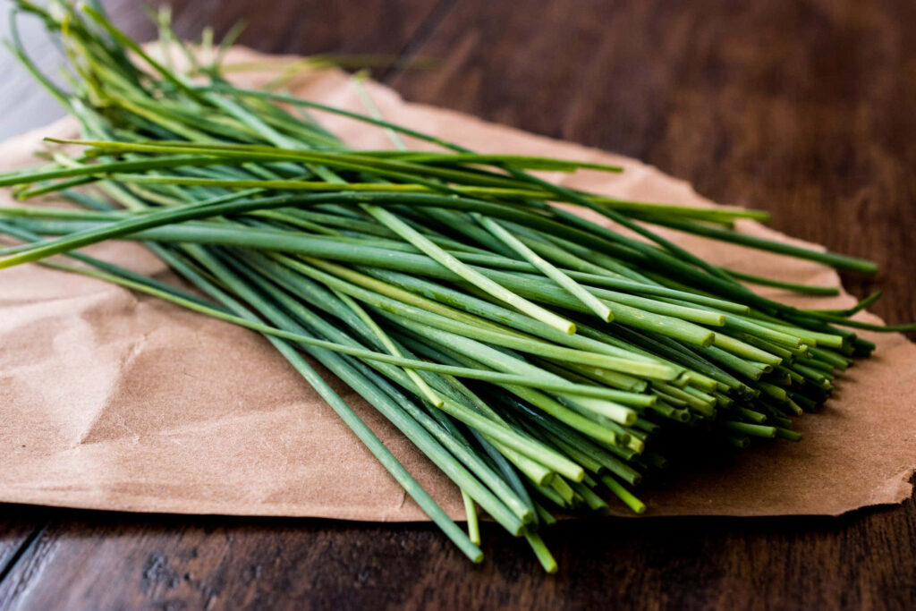 Vibrant Fresh Green Chives on Rustic Wood - Wallpaper Background