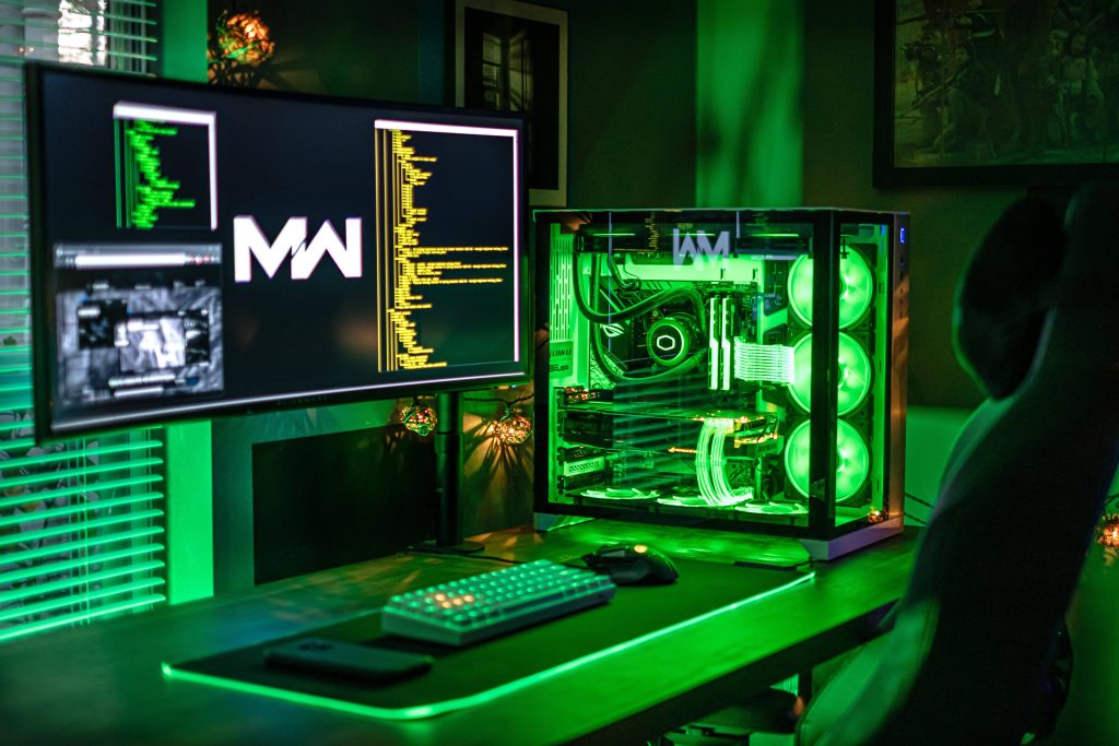 Gaming room wallpaper with green lighting high-end PC ultra-wide monitor Call of Duty Modern Warfare