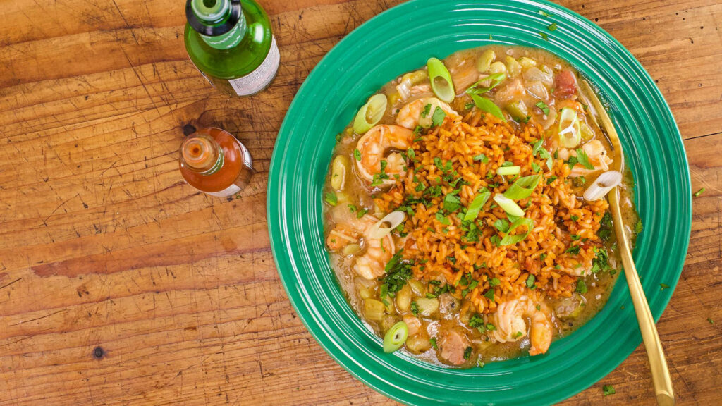 Vibrant Green Gumbo Bowl with Shrimp and Rice on Rustic Table Wallpaper