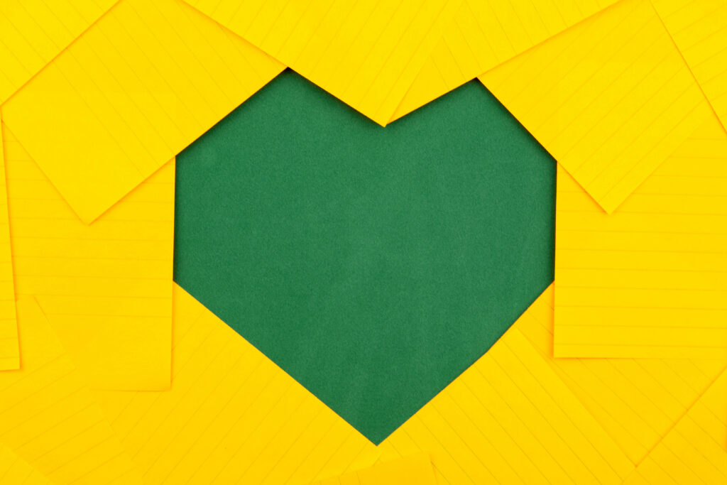 Minimalistic Green Heart Wallpaper with Yellow Paper Overlays