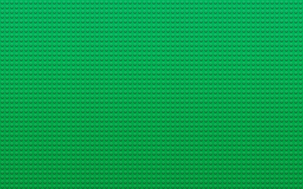 Vibrant green Lego baseplate with textured grid of circular studs playful background wallpaper