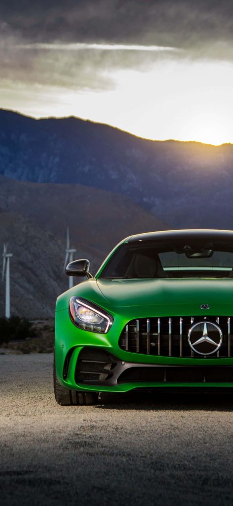 Green Mercedes-AMG GT R sports car at sunset with desert mountains and wind turbines wallpaper