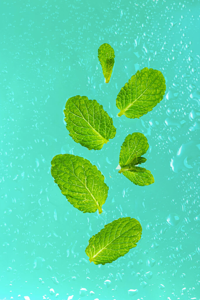 Vibrant Green Mint Leaves Wallpaper with Water Droplets - Macro View
