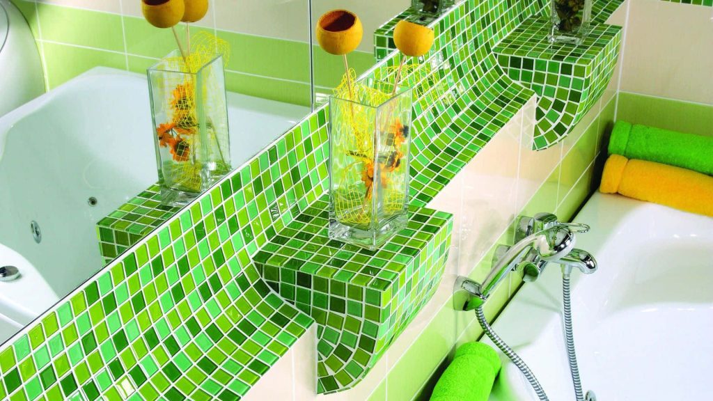 Spa-inspired bathroom wallpaper with green mosaic tiles white tub lime yellow towels and vases