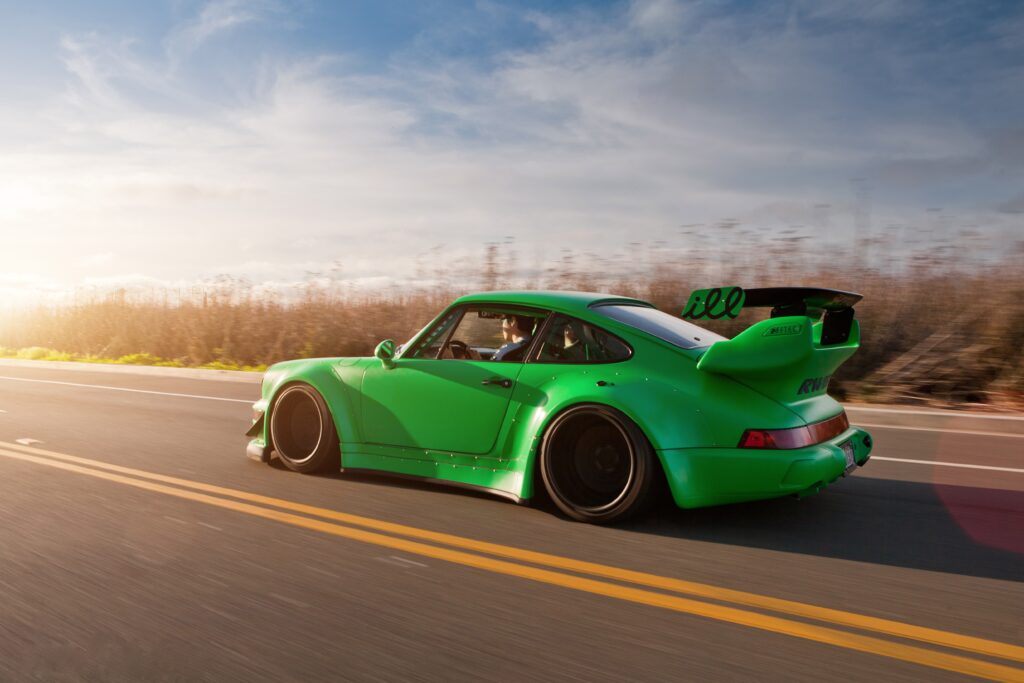 Vibrant Green Porsche 911 Racing Wallpaper: Sleek Design & Performance