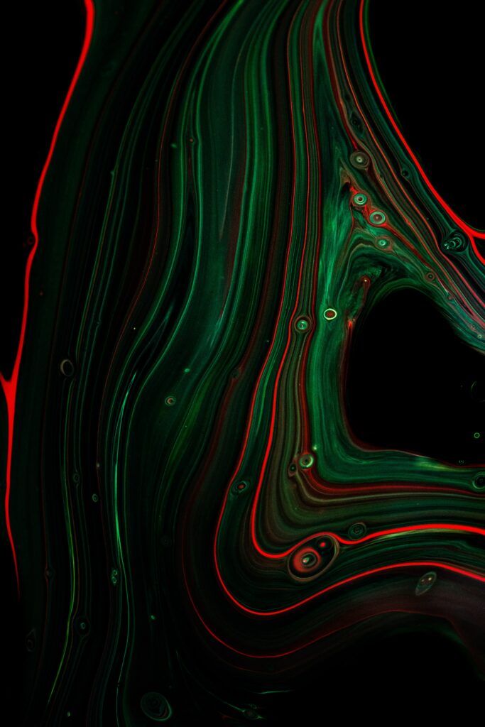 Vibrant Green & Red Abstract Wallpaper with Fluid Patterns