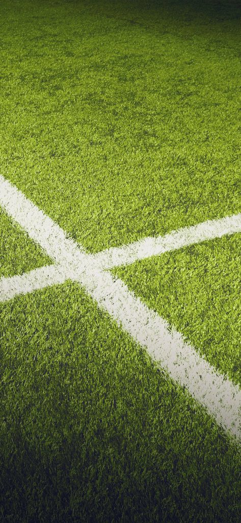 Close-up of vibrant green artificial turf with sharp white lines iPhone sports wallpaper background