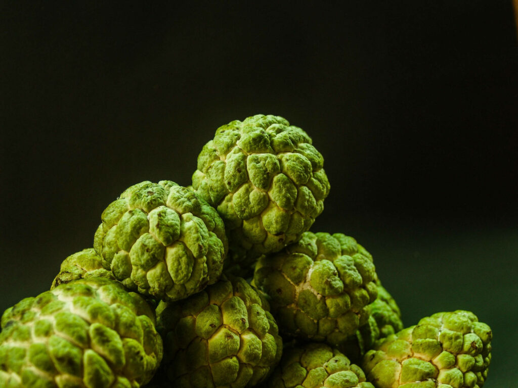 Vibrant Green Sugar Apples Wallpaper on Dark Background - Natural Beauty