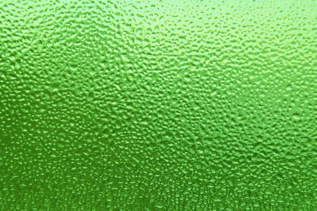 Vibrant Green Textured Wallpaper with Dimpled Ice Pattern Background