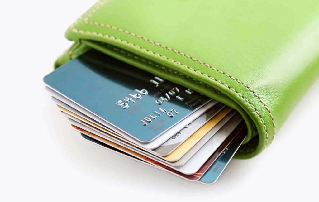 Close-up of green wallet with colorful credit cards organized for finance and budgeting wallpaper