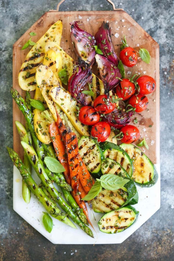 Vibrant Grilled Vegetables Wallpaper Background on Rustic Wood