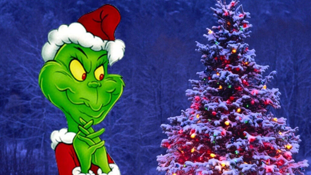 Festive Grinch Wallpaper: Mischievous Fun with a Snowy Christmas Tree