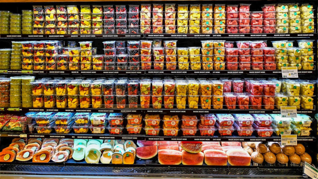 Vibrant Grocery Display: Fresh Fruits, Salads & Snacks Wallpaper
