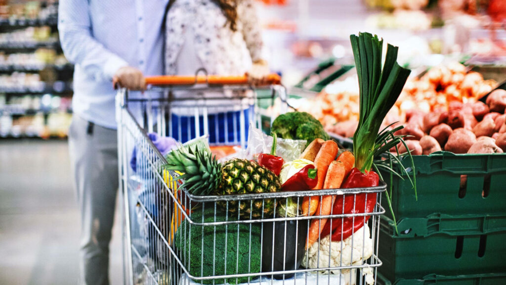 Vibrant Grocery Wallpaper: Shopping Cart with Fresh Produce Items