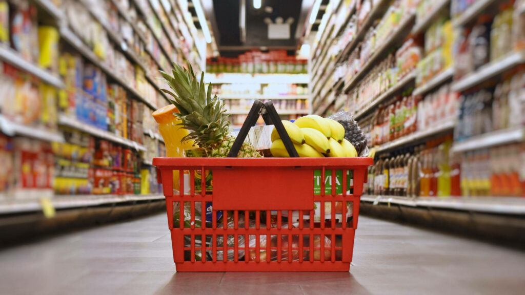 Vibrant Supermarket Wallpaper: Red Basket Full of Fresh Groceries