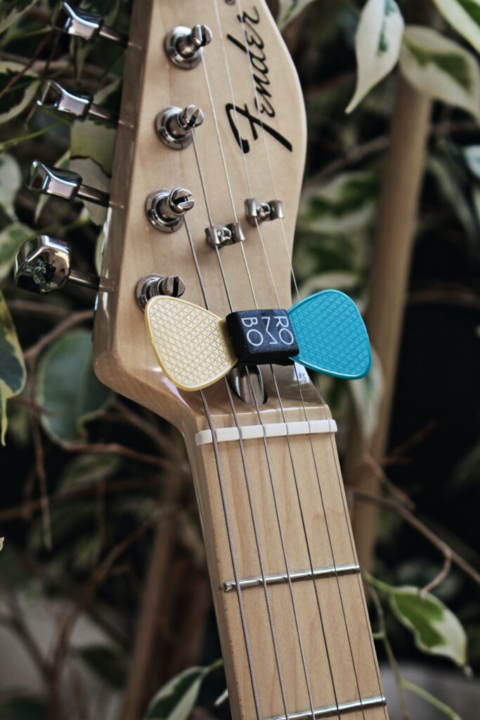 Vibrant Guitar Fretboard with Picks on Strings - Nature Wallpaper