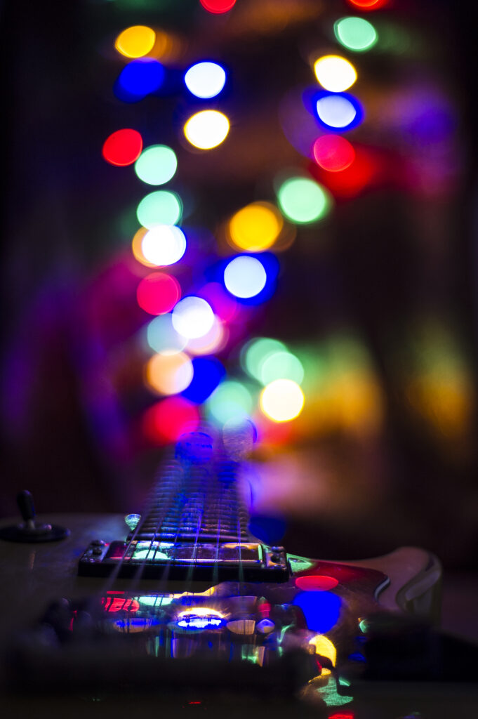 Vibrant Guitar Wallpaper: Close-Up with Colorful Bokeh Background