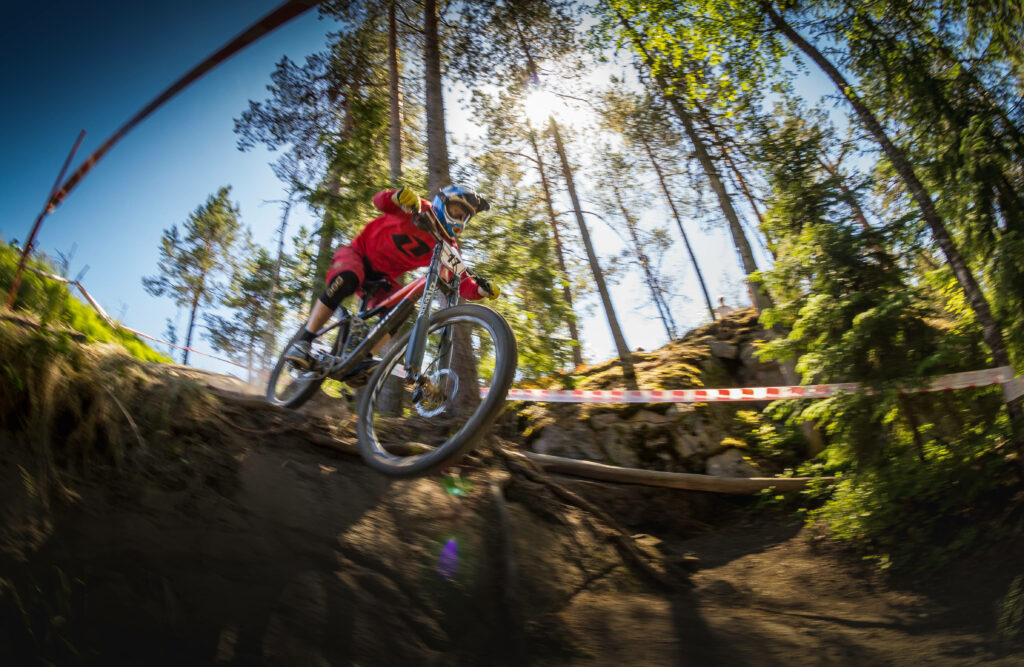 Vibrant HD Sports Wallpaper: Cyclist on Rugged Downhill Trail