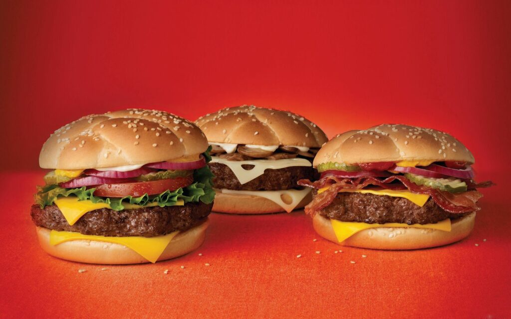 Vibrant Hamburger Wallpaper: Fresh Deliciousness on Bold Red