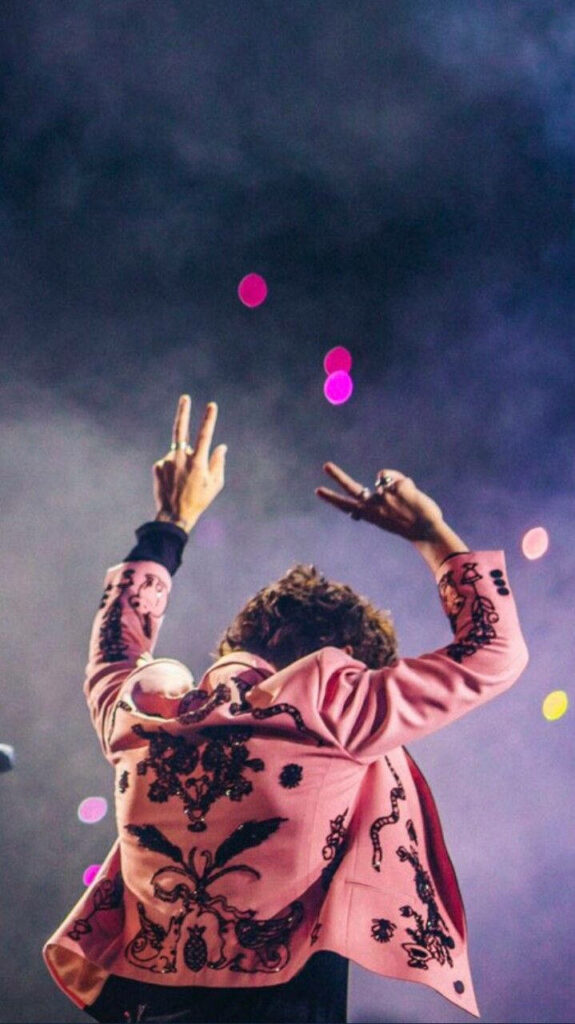 Vibrant Harry Styles Wallpaper: Peace Sign in Stylish Pink Jacket