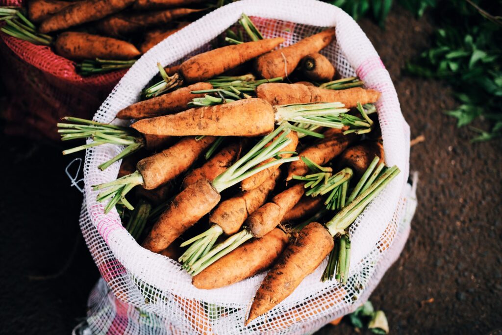 Vibrant Carrot Bag & Vegetables - Earthy Harvest Wallpaper