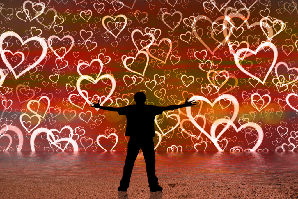 Vibrant Romantic Wallpaper: Silhouette with Glowing Heart Shapes