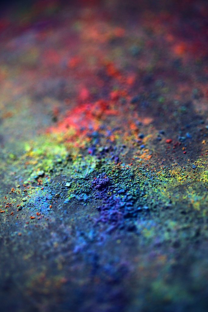 Close up of vibrant blue green and red gulal powder for colorful Holi festival celebration wallpaper