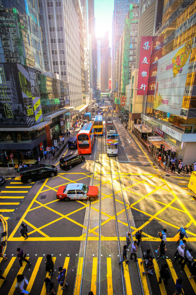 Vibrant Hong Kong Street Scene Wallpaper: Trams, Pedestrians, Skyscrapers
