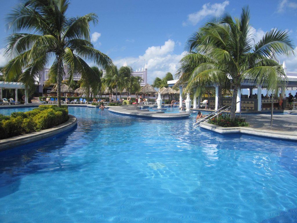 Hotel Riu Montego Bay pool with clear blue water and palm trees tropical Caribbean resort view Wallpaper