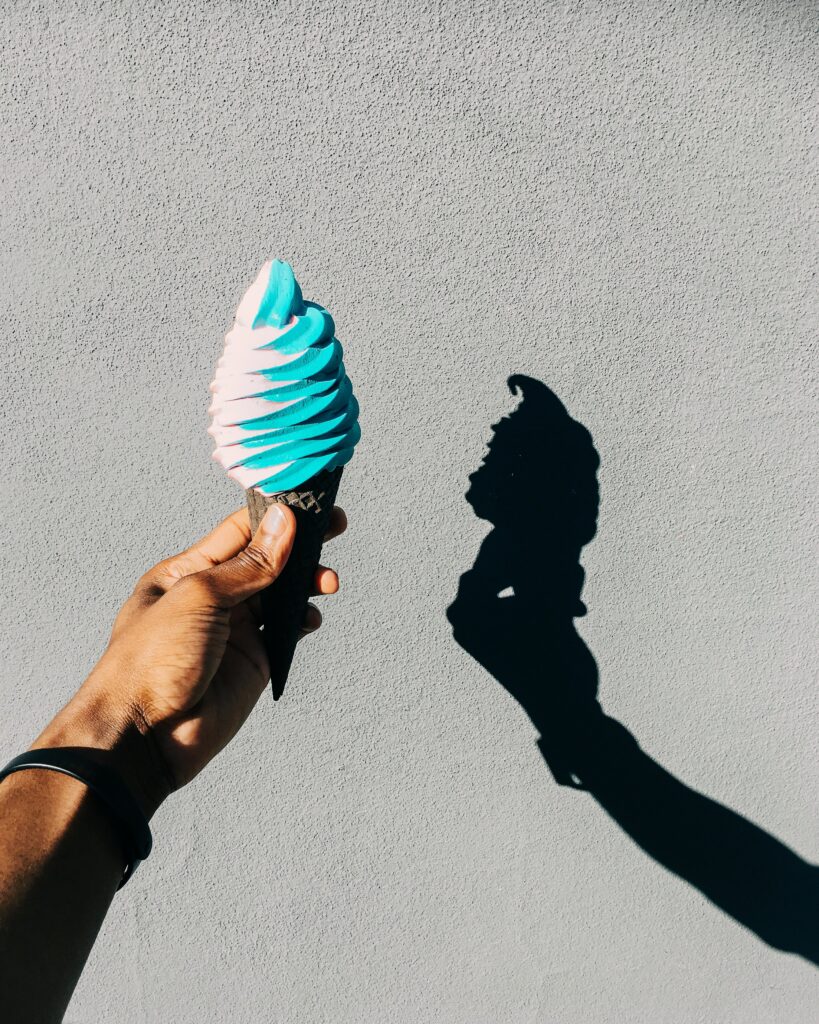 Colorful Ice Cream Cone Wallpaper with Dramatic Shadow Background