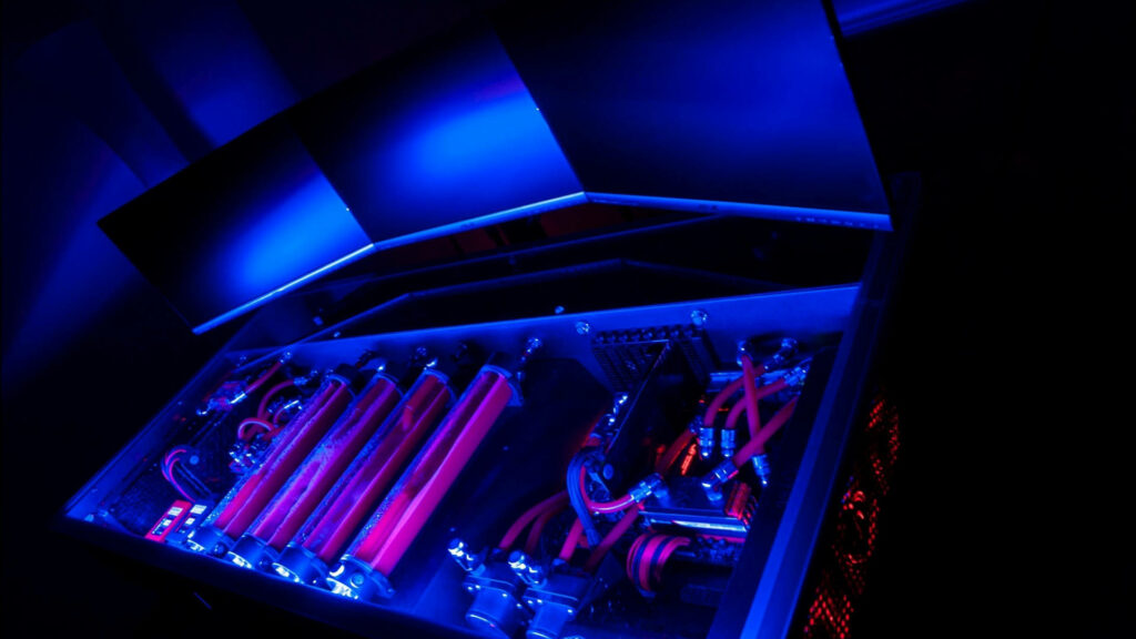 Translucent Tech Symphony: A Vibrant Workspace Illuminated in Blue and Purple Wallpaper