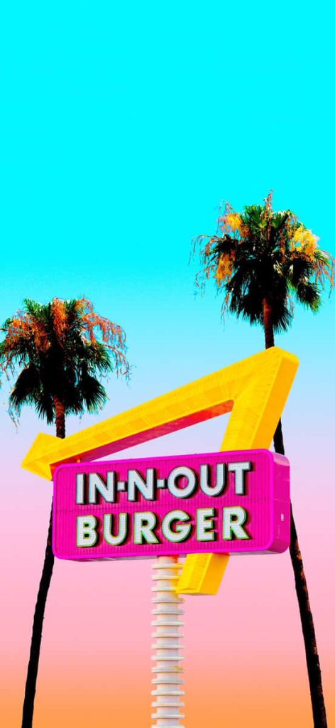 In-N-Out Burger wallpaper with yellow arrow sign palm trees blue to orange gradient sky retro California