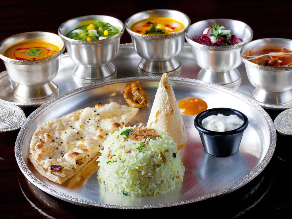 Elegant Indian Cuisine Wallpaper: Vibrant Rice, Naan & Curries
