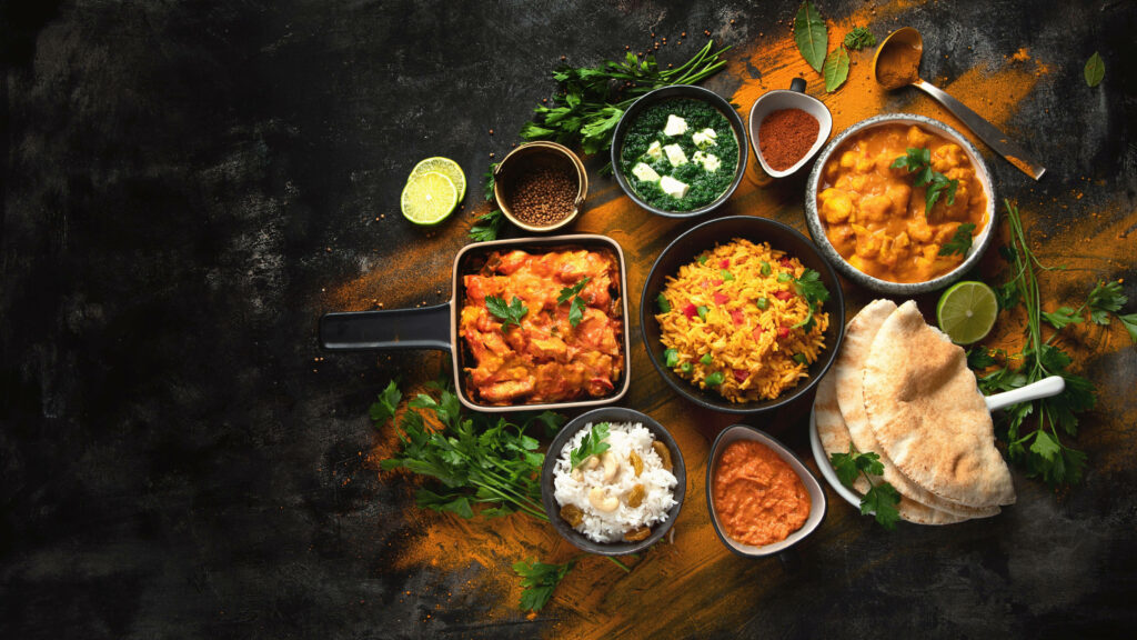 Vibrant Indian Cuisine Wallpaper: Curries, Rice, Naan & Chutneys