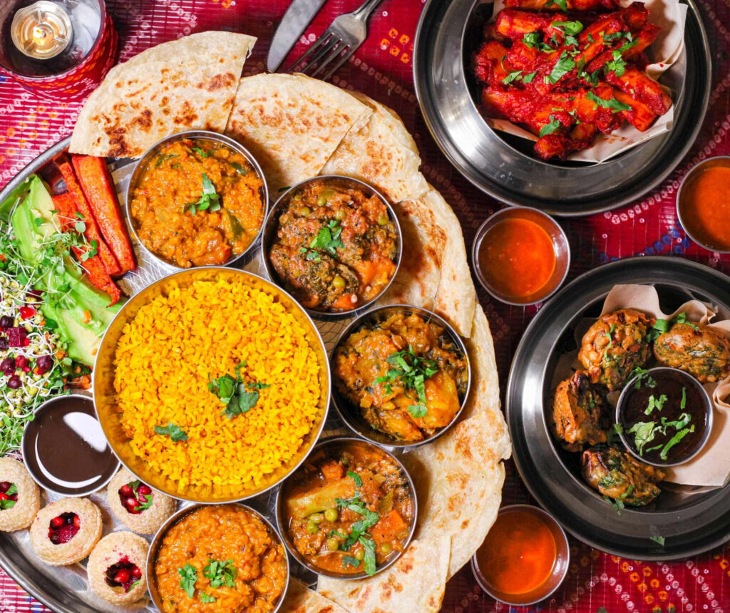 Vibrant Indian Food Spread Wallpaper: Colorful Curries & Naans