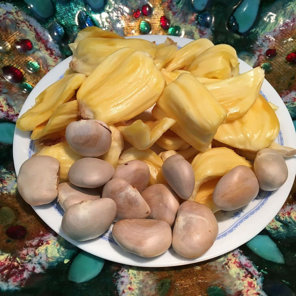 Vibrant Jackfruit Wallpaper: Golden Flesh & Seeds on Artistic Background