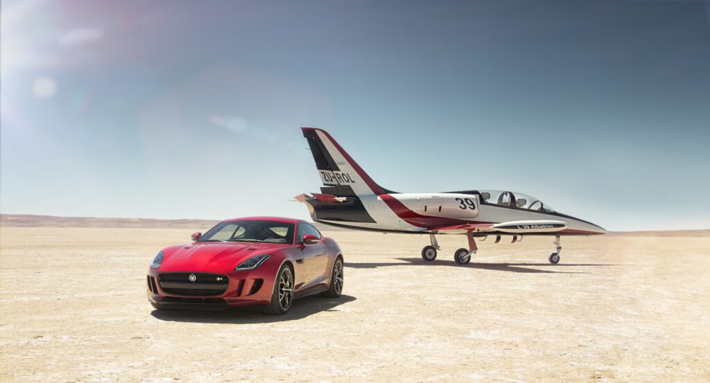 Striking Red Jaguar F-Type R Wallpaper: Luxury Speed Landscape