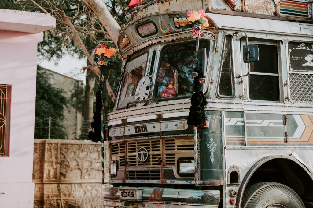 Festive Jaipur Wallpaper: Colorful Bus with Floral Patterns