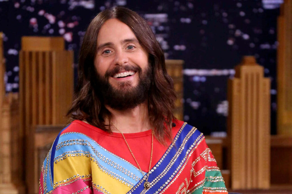 Jared Leto Wallpaper: Colorful City Skyline Background with Long Hair