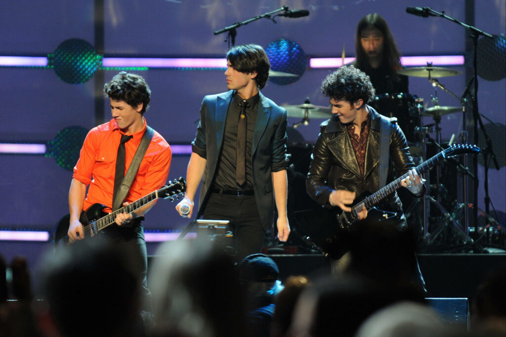 Dynamic Jonas Brothers Concert Wallpaper - Vibrant Stage Performance