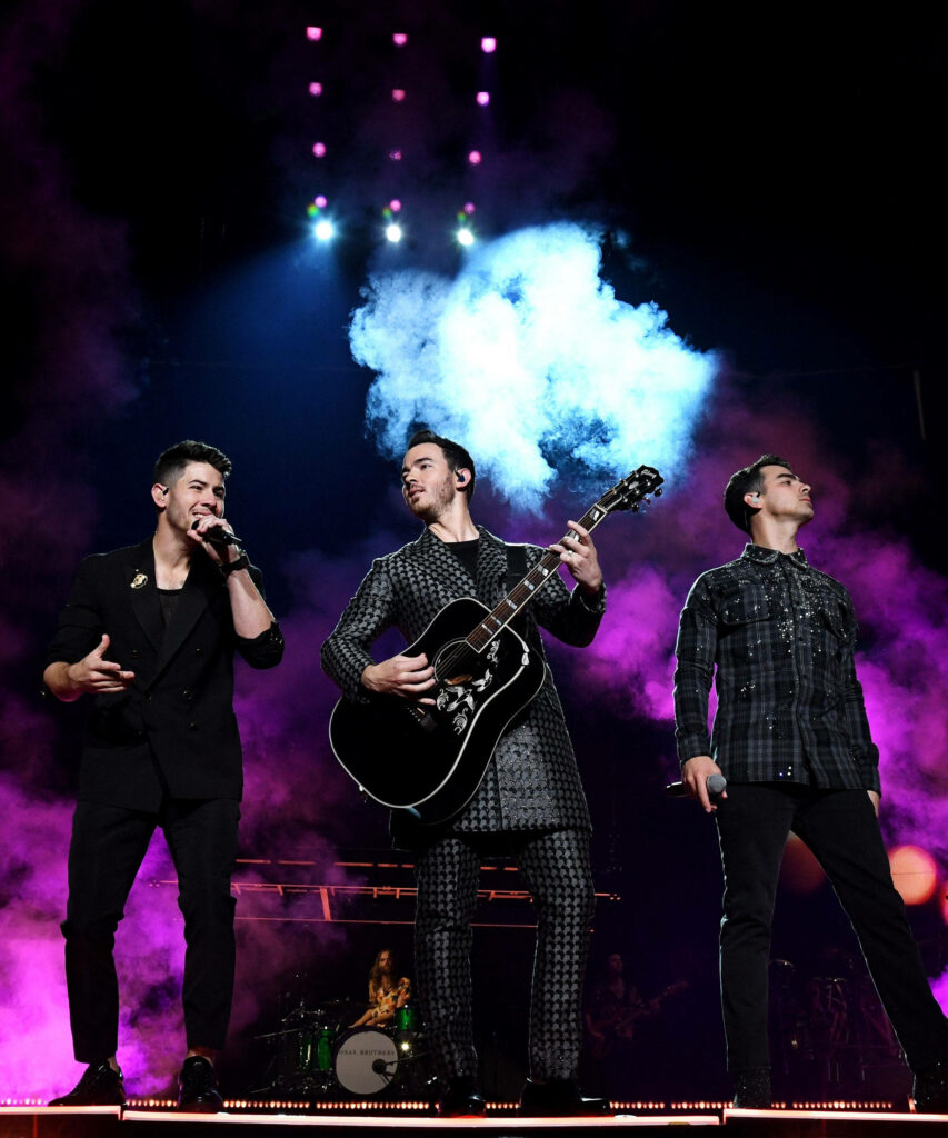 Vibrant Jonas Brothers Performance Wallpaper Background