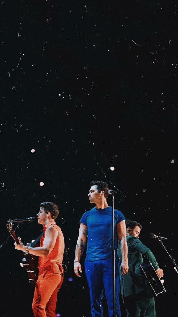 Vibrant Jonas Brothers Wallpaper: Passionate Performance Background