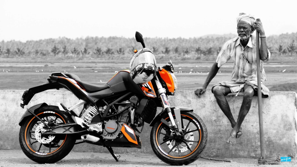Serene Countryside Wallpaper: Sleek Orange KTM Bike in Rustic Setting