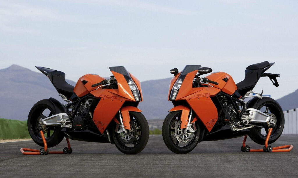 Vibrant KTM RC8 Bikes Wallpaper with Scenic Mountain Track Background