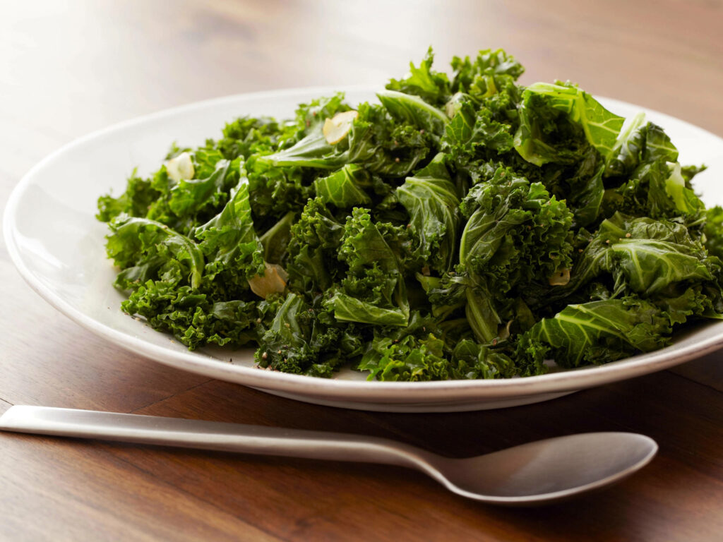 Vibrant Kale Wallpaper: Fresh Green Plate on Wooden Table