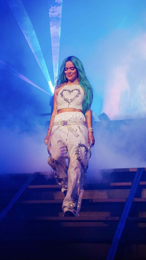 Vibrant Karol G Concert Entrance Wallpaper: Turquoise Hair & Blue Lights