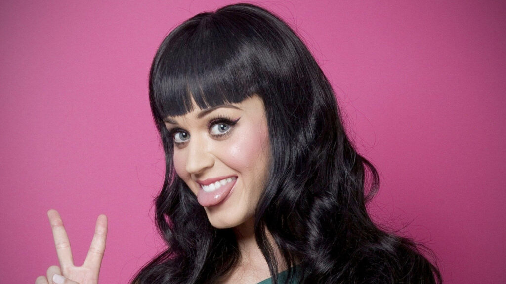 Vibrant Katy Perry Wallpaper: Pink Background & Cheerful Peace Sign