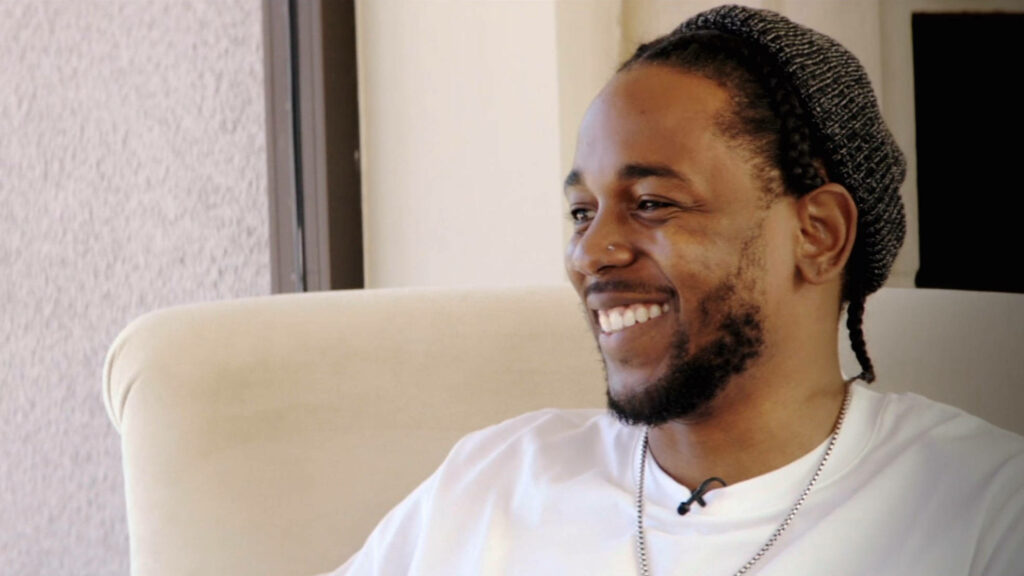 Vibrant Kendrick Lamar Wallpaper: Smiling & Exuding Positivity